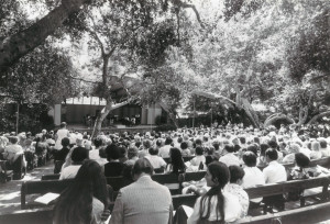 black and white film photo of an audience seated outdoors