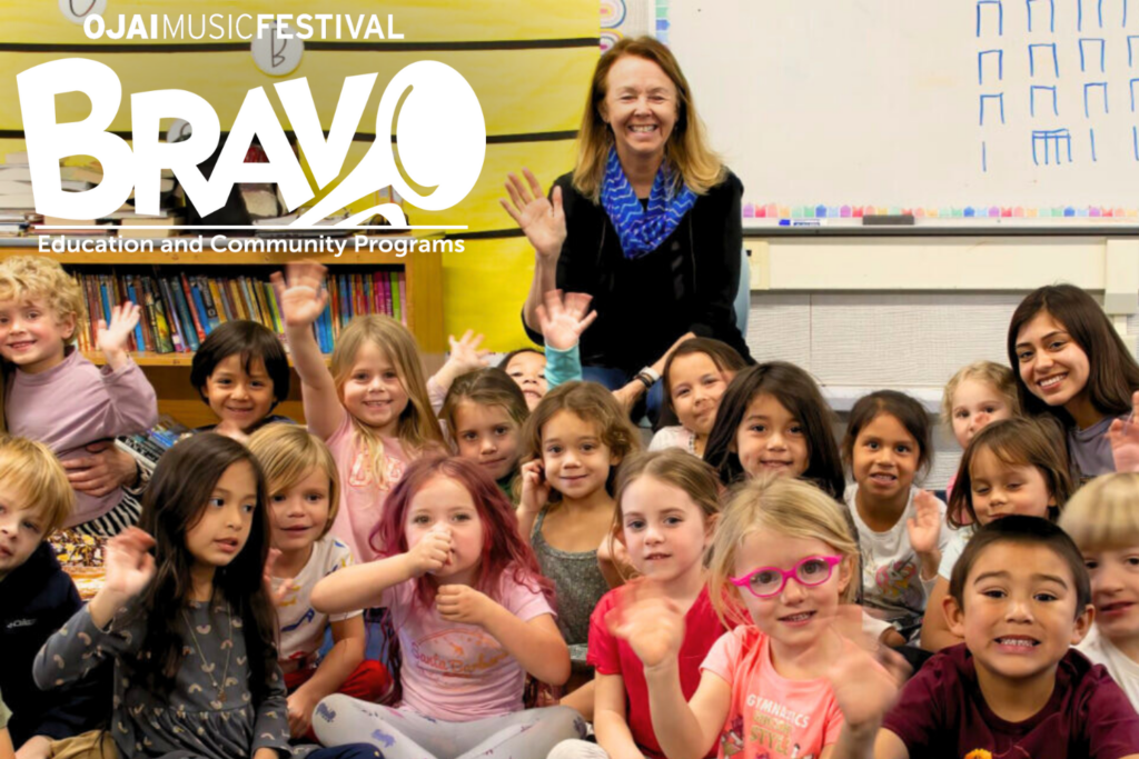 Classroom full of smiling children waving