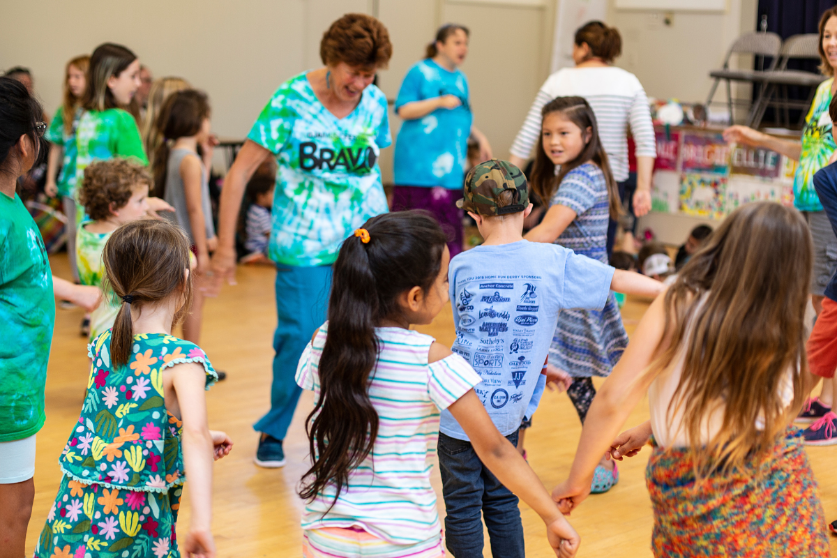 Campers and OFWC Volunteers dance at summer camp