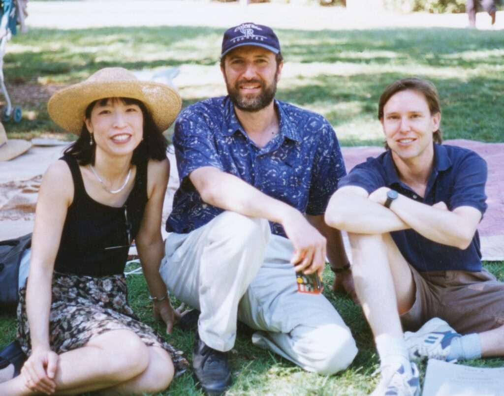 Gloria Cheng, Ara Guzelimian and Grant Gershon sit on the lawn together